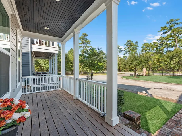 a view of a porch with wooden floor and fence