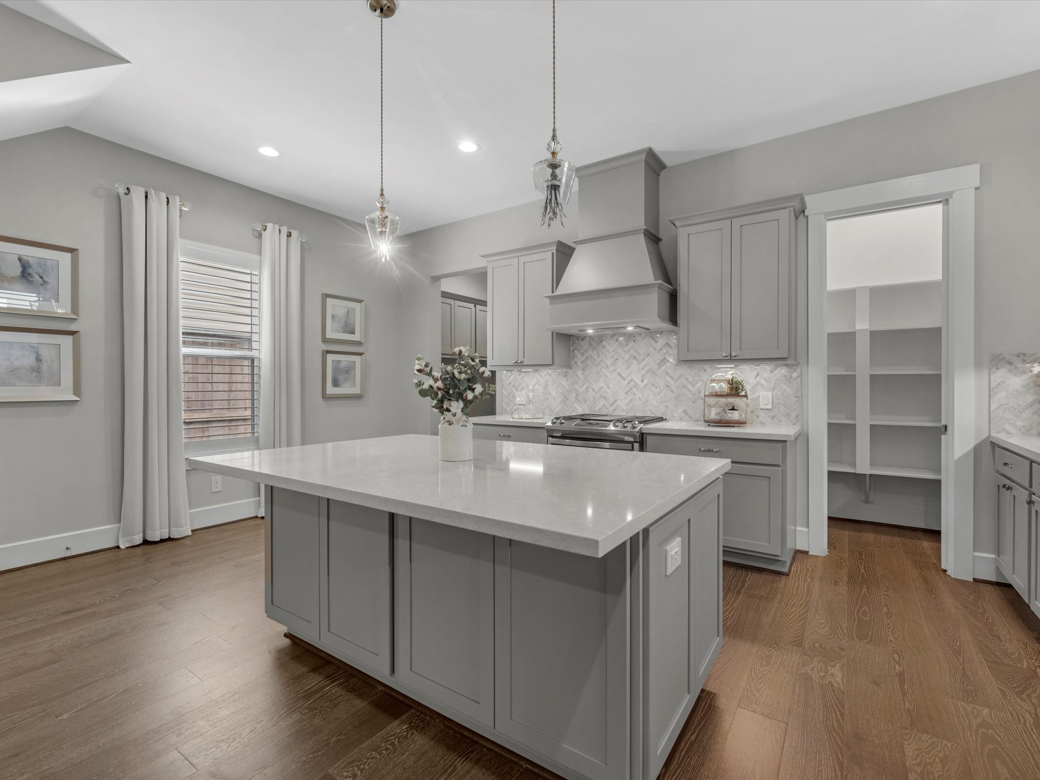 15 Black Dog Lane Spring, TX 77389 - Photo 8 of 32 a kitchen with stainless steel appliances a sink a stove a refrigerator and island with wooden floor