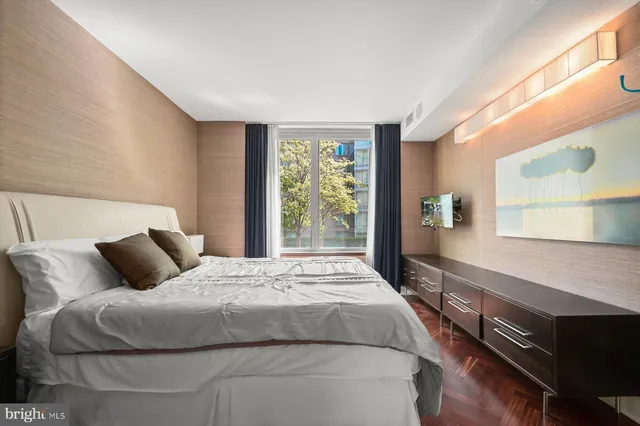 a bedroom with a large bed and a window