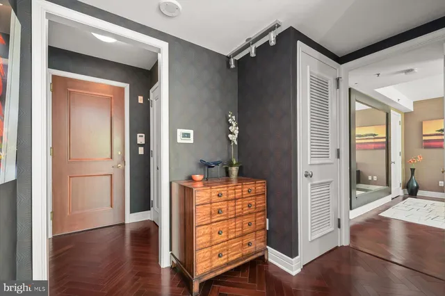 a view of a hallway with wooden floor and windows