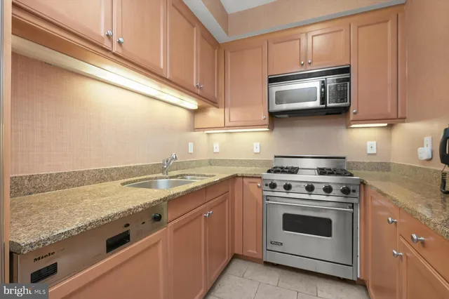 a kitchen with a stove microwave and sink