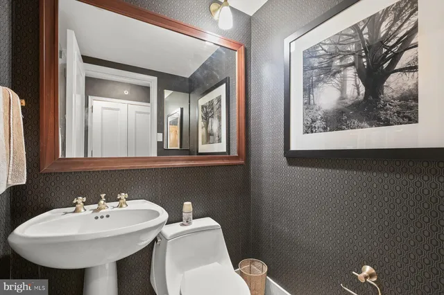 a bathroom with a toilet sink and mirror