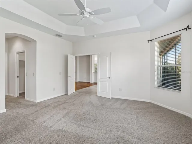 a bathroom with a double vanity sink a window and a mirror