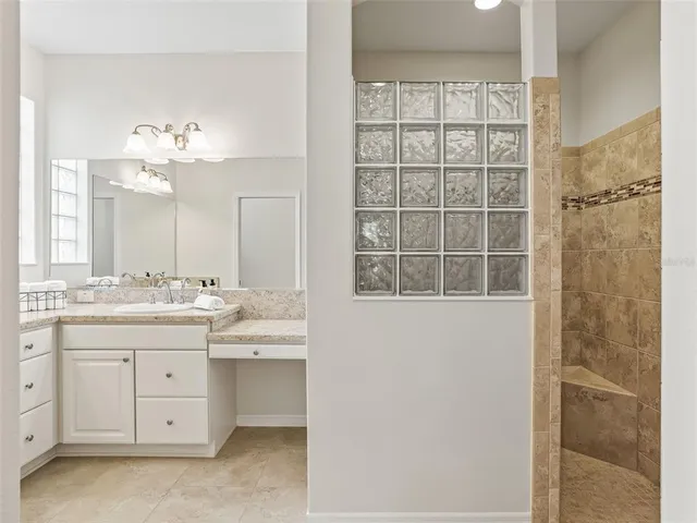 a view with double vanity sink and a mirror