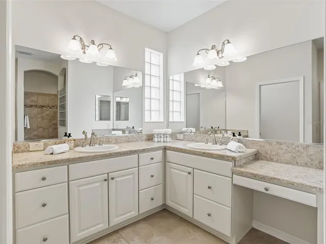 a bathroom with a sink vanity and mirror