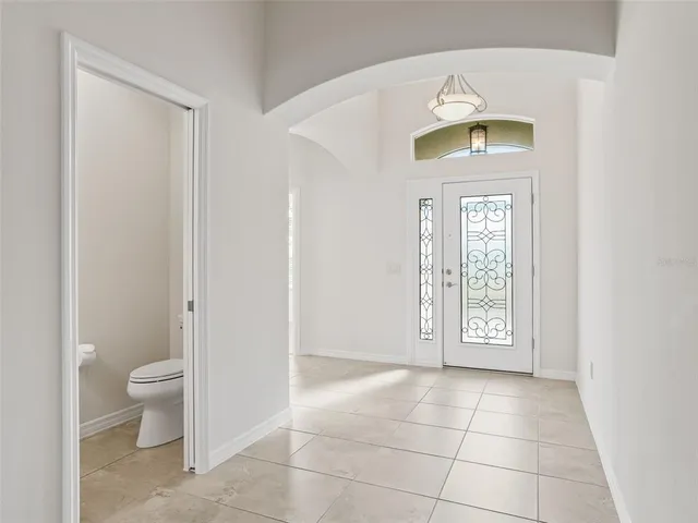 a en suite bathroom with a granite countertop sink and a mirror