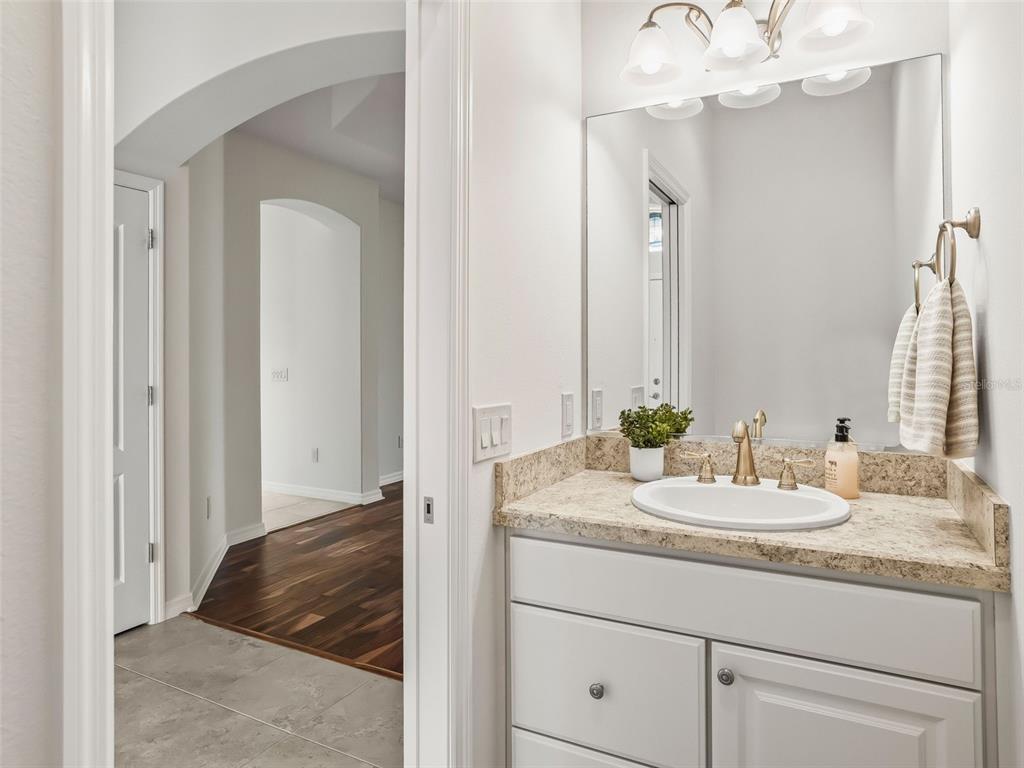 3229 Killington Loop The Villages, FL 32163 - Photo 25 of 44 a en suite bathroom with a granite countertop sink and a mirror