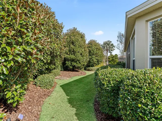 a view of a house with a yard and plants