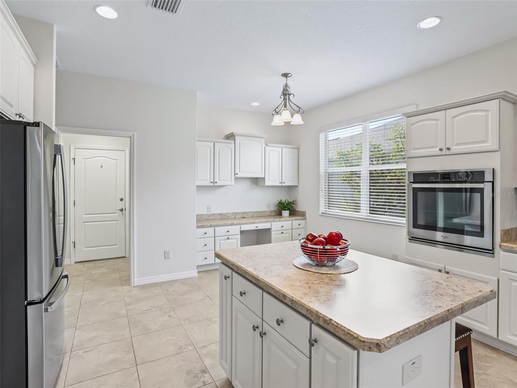 3229 Killington Loop The Villages, FL 32163 - Photo 6 of 44 a kitchen with granite countertop a sink cabinets and stainless steel appliances