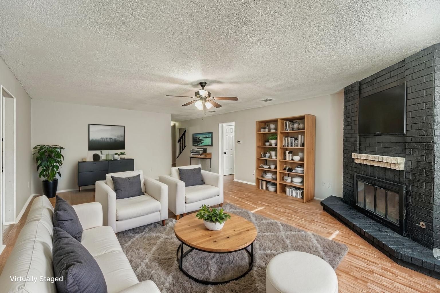 a living room with furniture and a wooden floor
