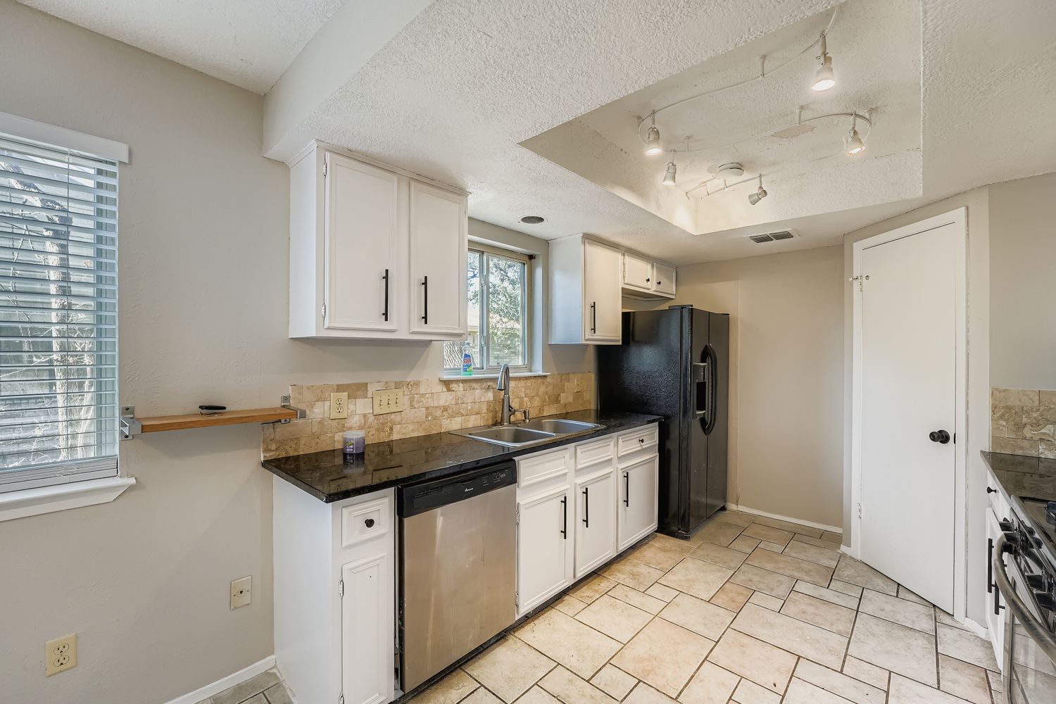 1415 Lance Way Austin, TX 78758 - Photo 11 of 29 a kitchen with stainless steel appliances granite countertop a sink stove and cabinets