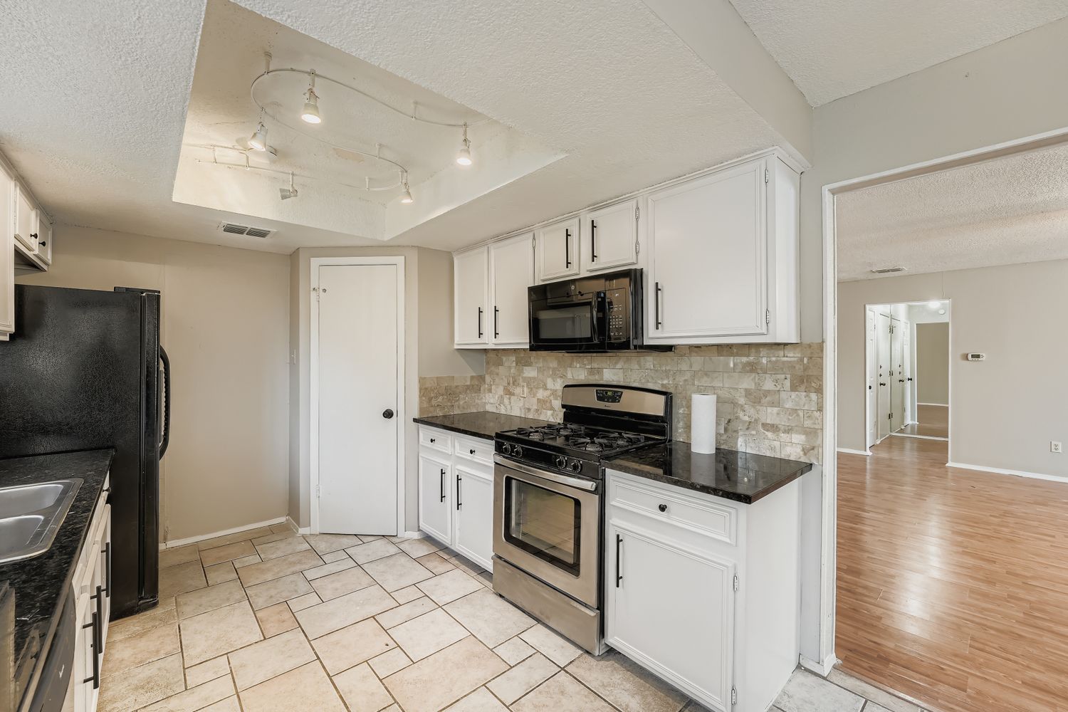 1415 Lance Way Austin, TX 78758 - Photo 12 of 29 a kitchen with stainless steel appliances a stove microwave and a refrigerator