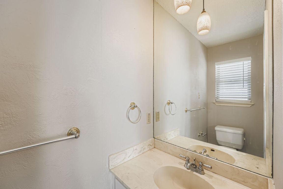 1415 Lance Way Austin, TX 78758 - Photo 16 of 29 a bathroom with a sink a toilet and shower