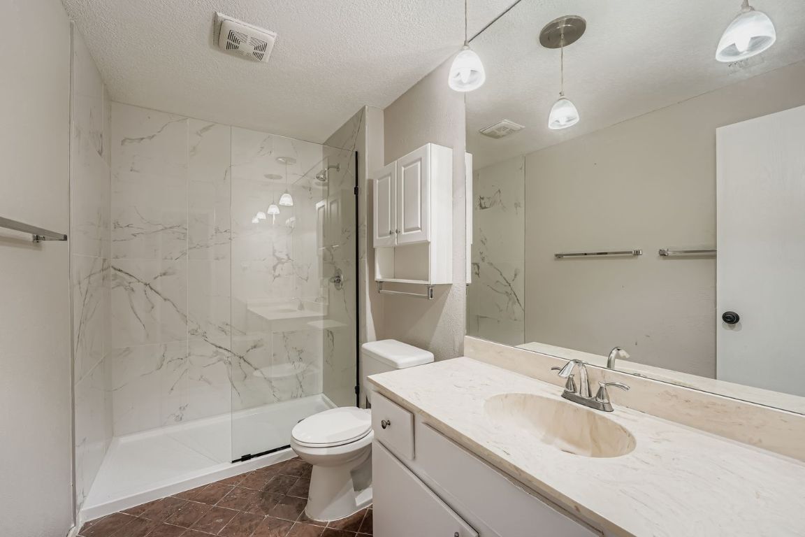 1415 Lance Way Austin, TX 78758 - Photo 23 of 29 a bathroom with a sink a toilet and shower