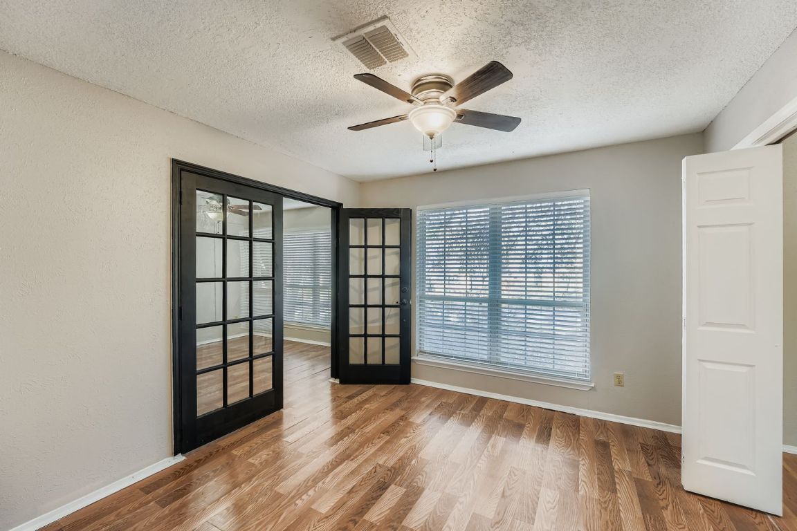 1415 Lance Way Austin, TX 78758 - Photo 25 of 29 wooden floor in an empty room with a window