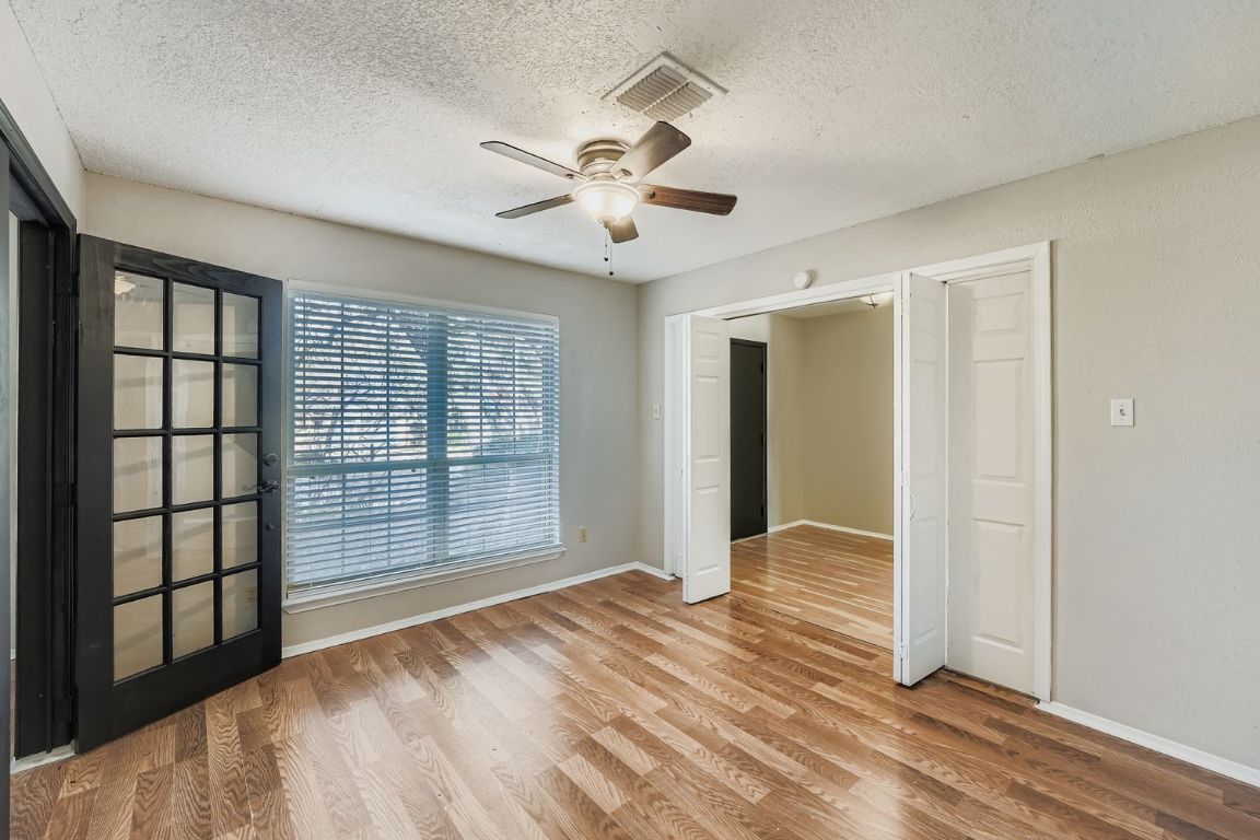 1415 Lance Way Austin, TX 78758 - Photo 26 of 29 a view of empty room with wooden floor and fan
