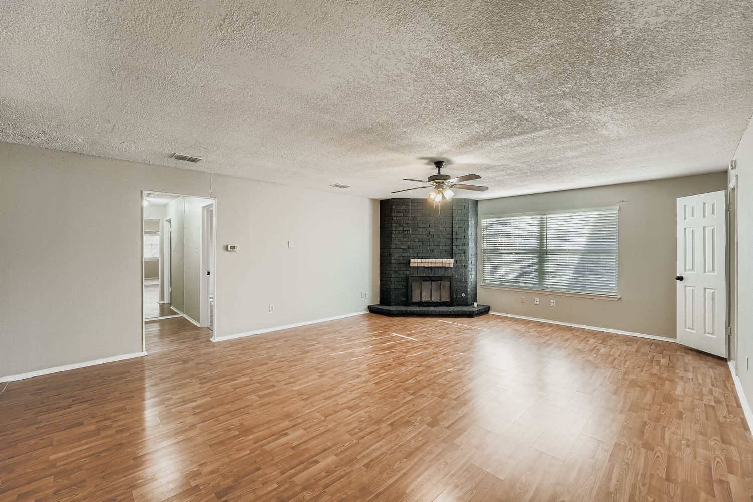 1415 Lance Way Austin, TX 78758 - Photo 6 of 29 wooden floor in an empty room with a fireplace