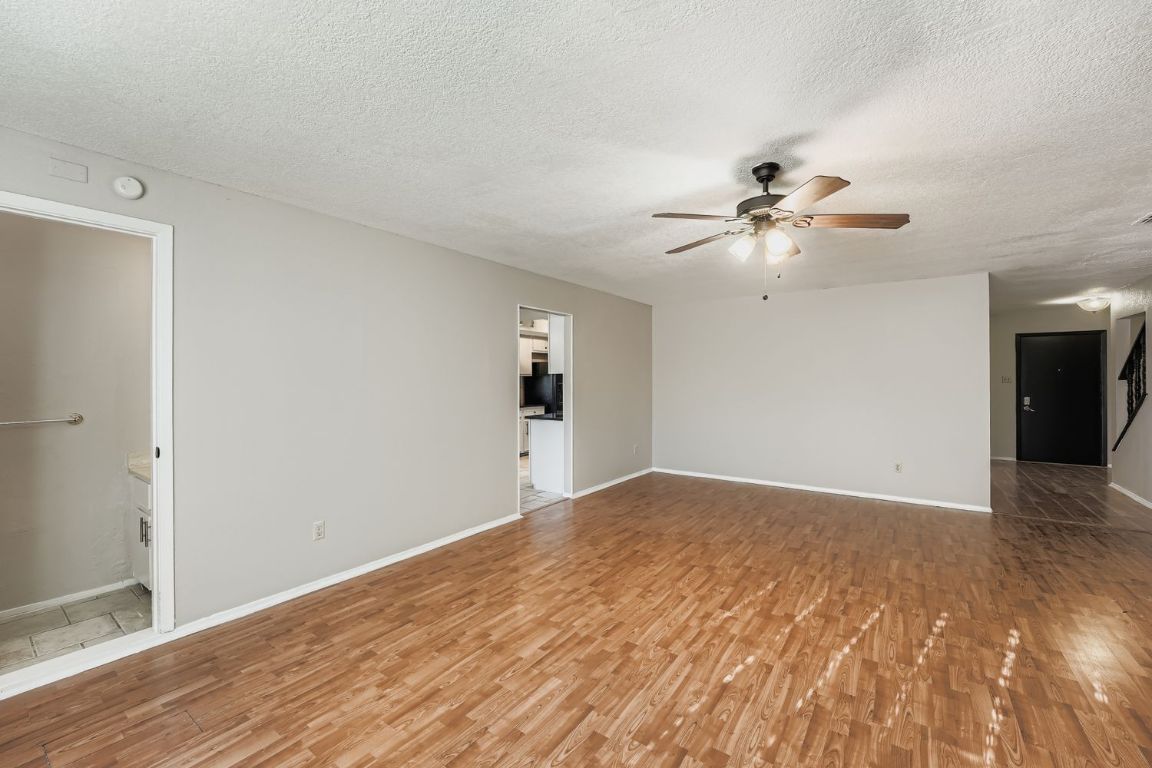 1415 Lance Way Austin, TX 78758 - Photo 8 of 29 a view of empty room with wooden floor