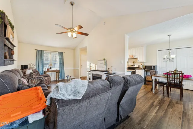 a living room with furniture a ceiling fan and a rug