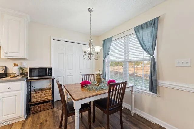 a view of a dining room with furniture window and wooden floor