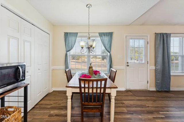 a dining room with furniture window and wooden floor