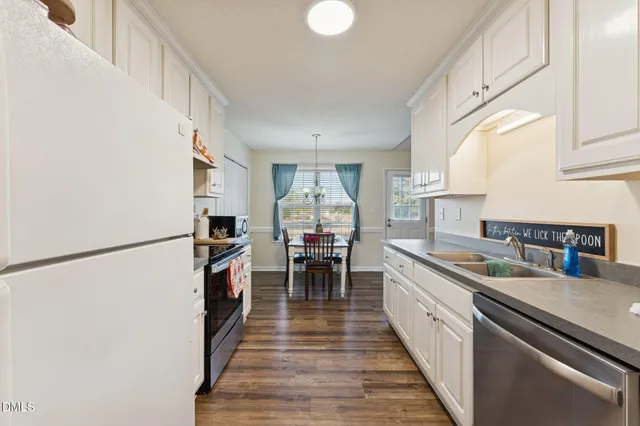 a kitchen with a sink appliances and cabinets