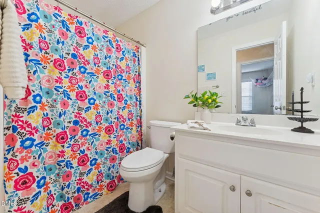 a bathroom with a sink toilet and mirror