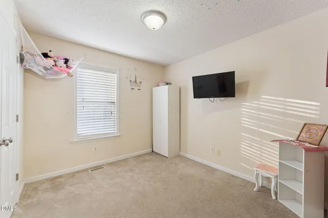 a view of livingroom with workspace and a window
