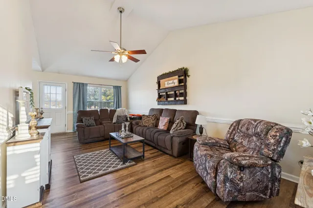 a living room with furniture or couch and a chandelier