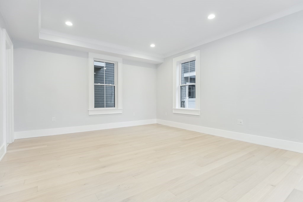 13 McKone Street, Unit 1 Boston, MA 02122 - Photo 12 of 36 an empty room with windows