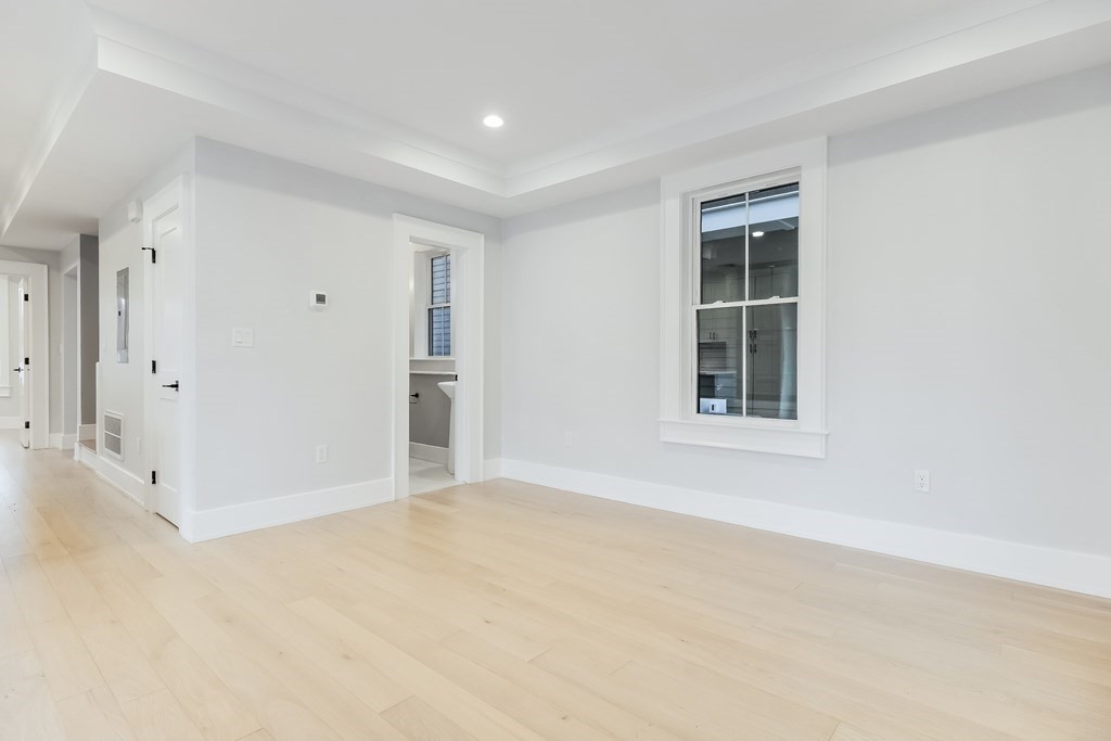 13 McKone Street, Unit 1 Boston, MA 02122 - Photo 13 of 36 an empty room with windows