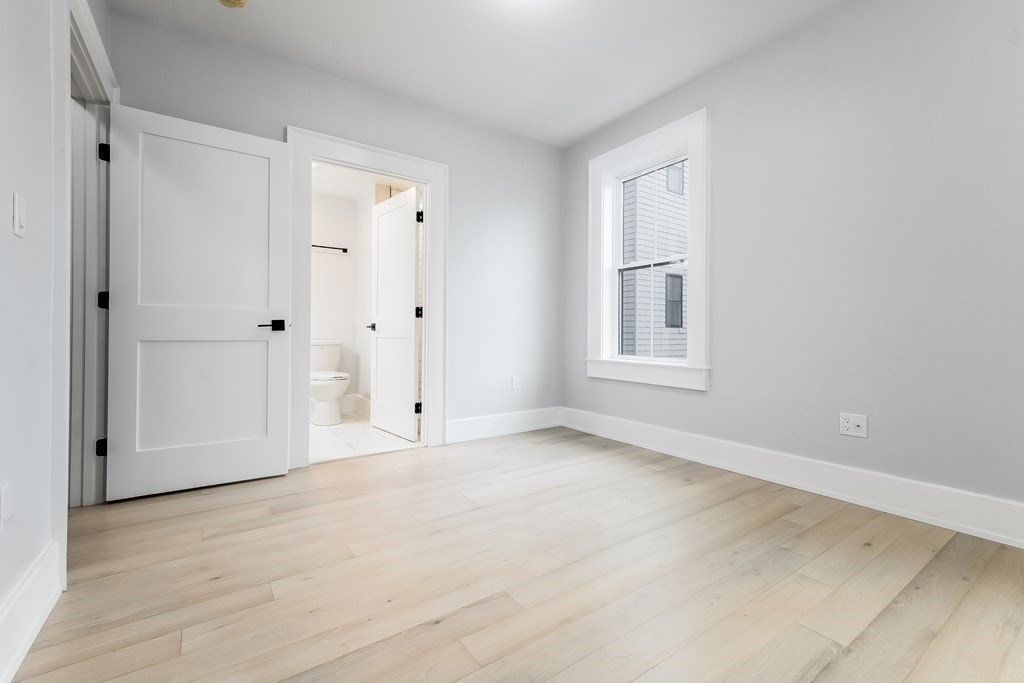 13 McKone Street, Unit 1 Boston, MA 02122 - Photo 21 of 36 a view of an empty room with a window