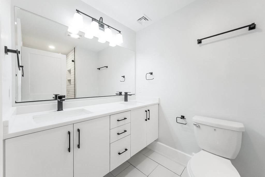13 McKone Street, Unit 1 Boston, MA 02122 - Photo 22 of 36 a bathroom with a double vanity sink mirror and toilet