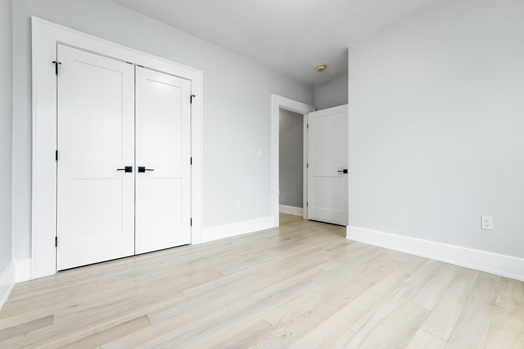 13 McKone Street, Unit 1 Boston, MA 02122 - Photo 24 of 36 an empty room with wooden floor