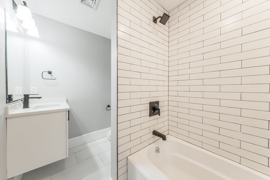 13 McKone Street, Unit 1 Boston, MA 02122 - Photo 26 of 36 a bathroom with a sink a toilet and shower