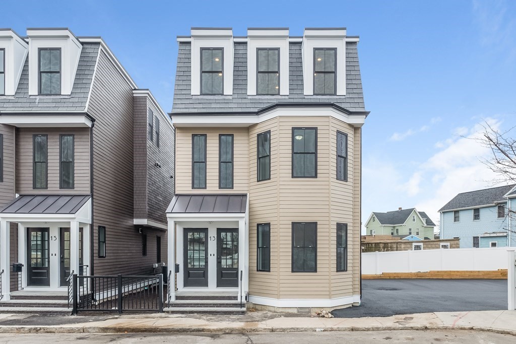 13 McKone Street, Unit 1 Boston, MA 02122 - Photo 29 of 36 a front view of a residential apartment building with a yard