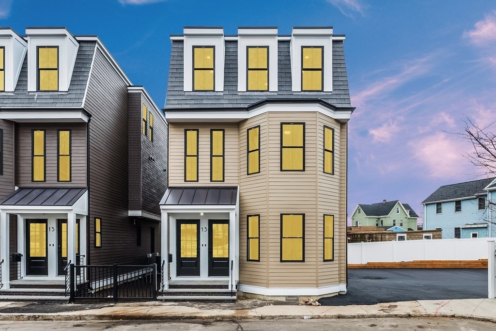 13 McKone Street, Unit 1 Boston, MA 02122 - Photo 30 of 36 a front view of a residential apartment building with a yard