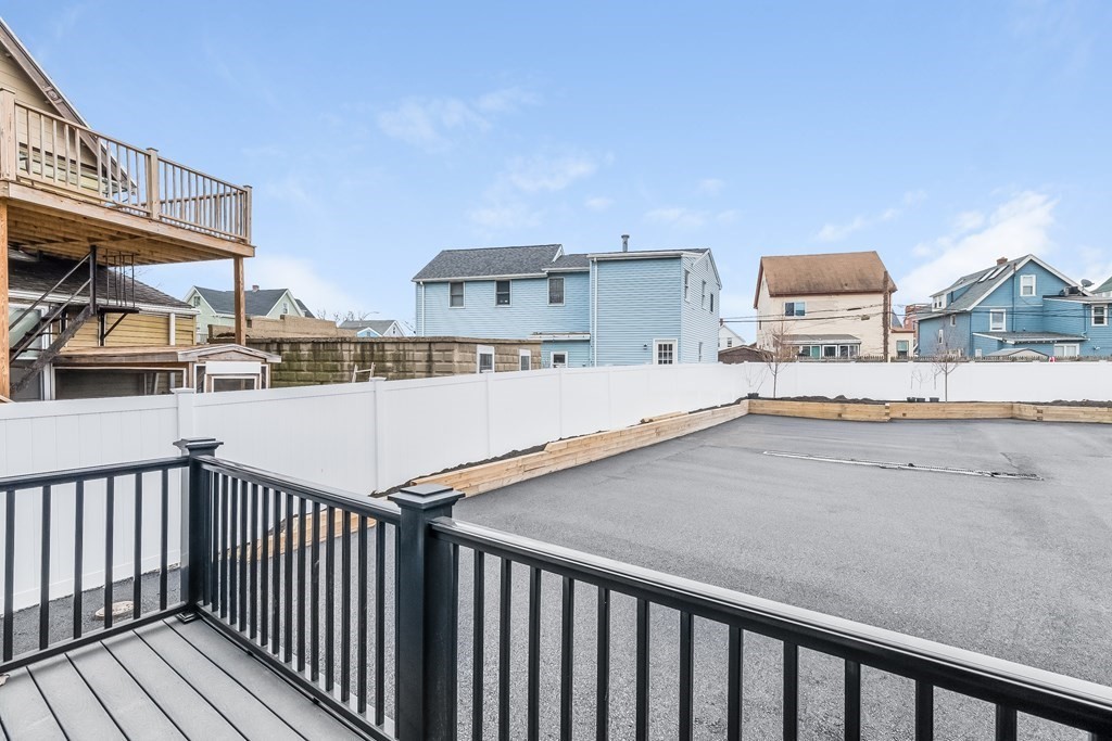 13 McKone Street, Unit 1 Boston, MA 02122 - Photo 32 of 36 a view of a house with a wooden deck