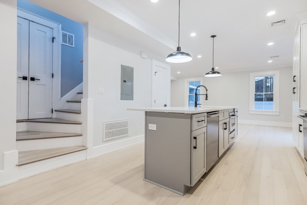 13 McKone Street, Unit 1 Boston, MA 02122 - Photo 4 of 36 a kitchen with stainless steel appliances granite countertop a sink a stove and a refrigerator