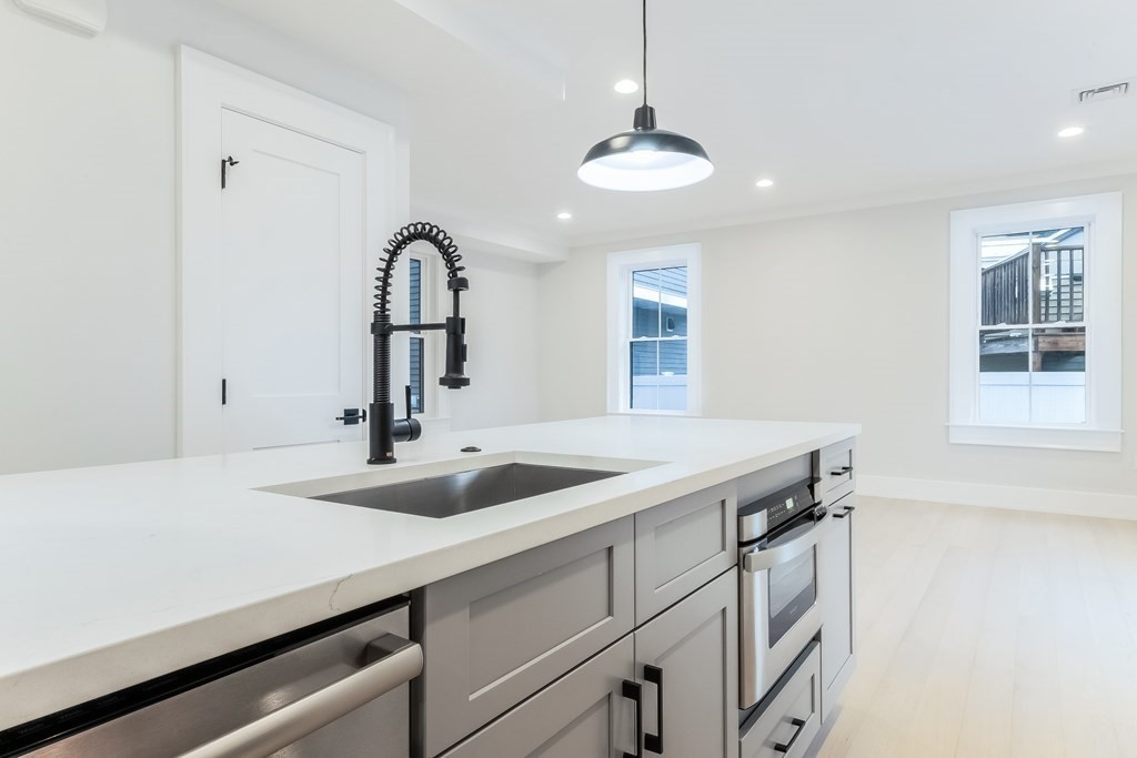 13 McKone Street, Unit 1 Boston, MA 02122 - Photo 6 of 36 a kitchen with a sink and a refrigerator