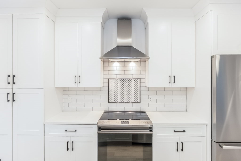 13 McKone Street, Unit 1 Boston, MA 02122 - Photo 7 of 36 a kitchen with a stove and a cabinet