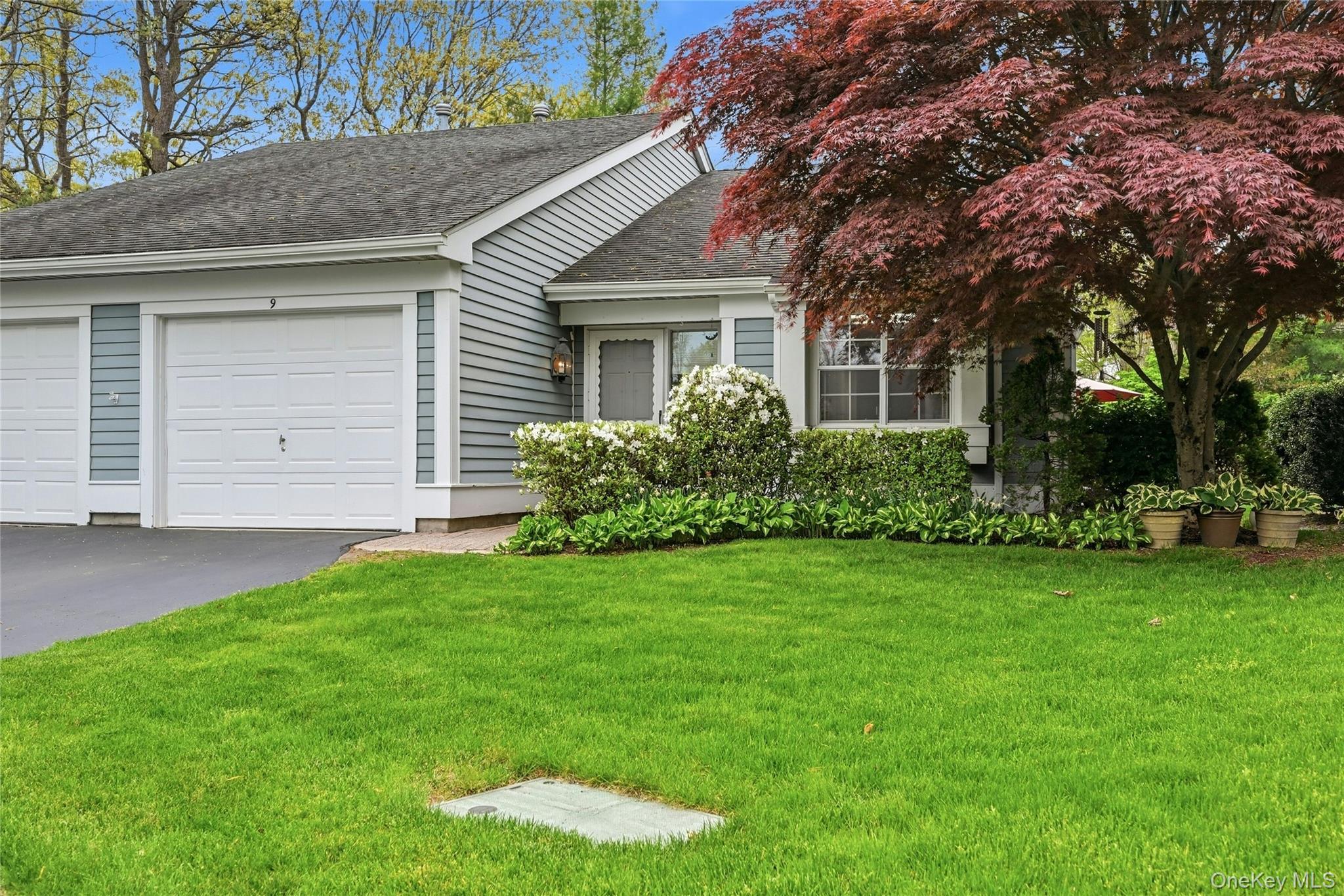 9 Baldwin Court, Unit 9 Ridge, NY 11961 - Photo 1 of 27 front view of a house with a garden