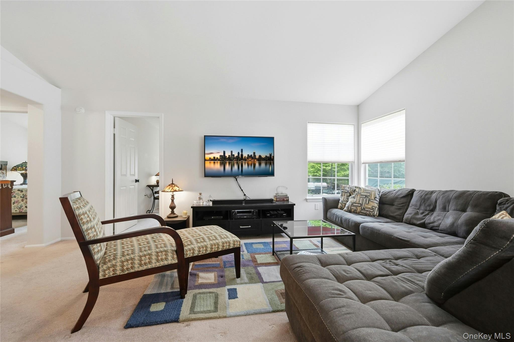 9 Baldwin Court, Unit 9 Ridge, NY 11961 - Photo 14 of 27 a living room with furniture and a large window