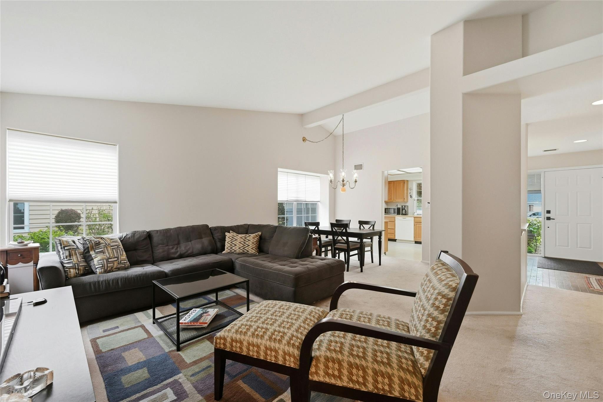 9 Baldwin Court, Unit 9 Ridge, NY 11961 - Photo 16 of 27 a living room with furniture and a large window