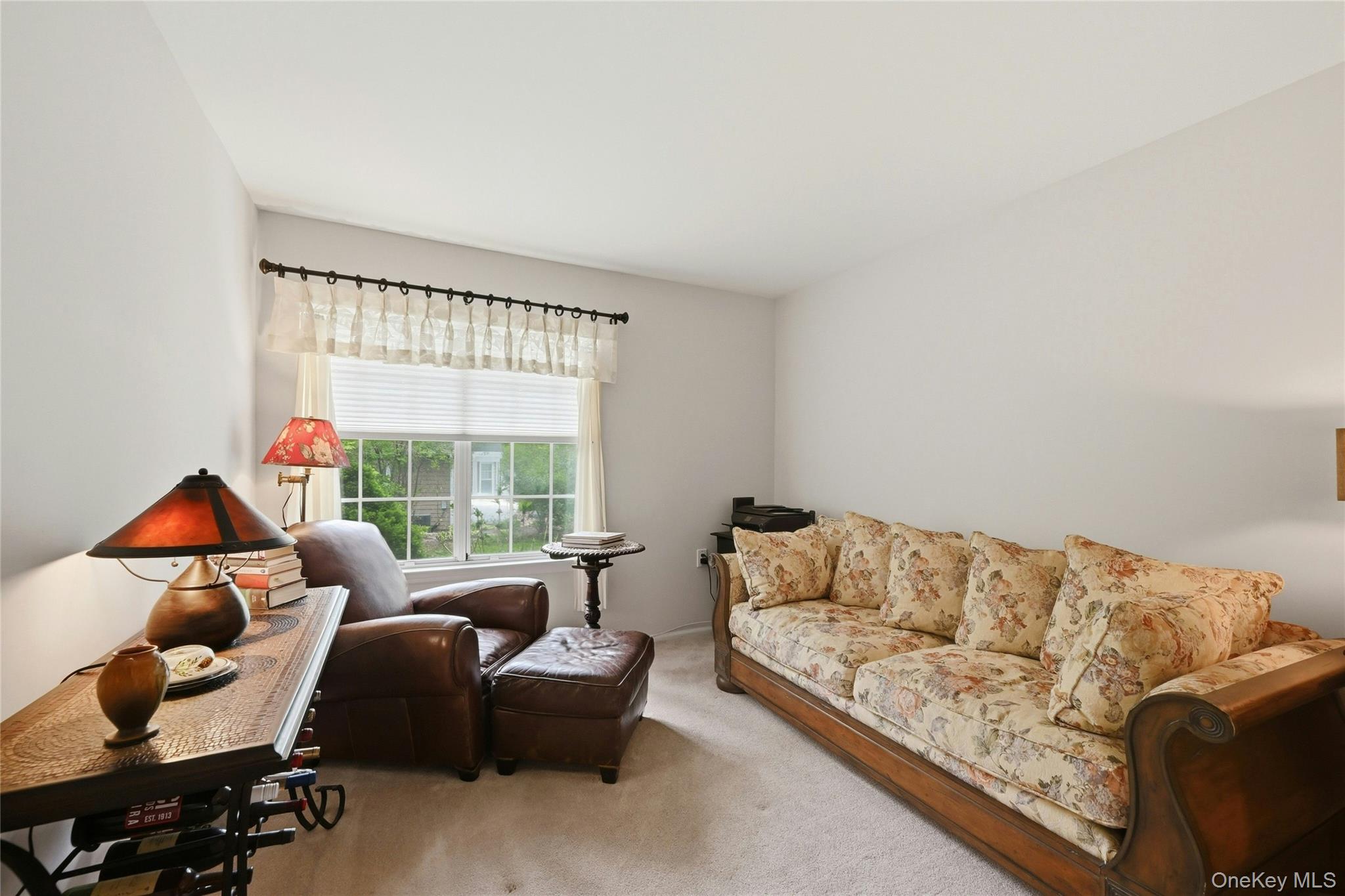 9 Baldwin Court, Unit 9 Ridge, NY 11961 - Photo 17 of 27 a living room with furniture and a large window