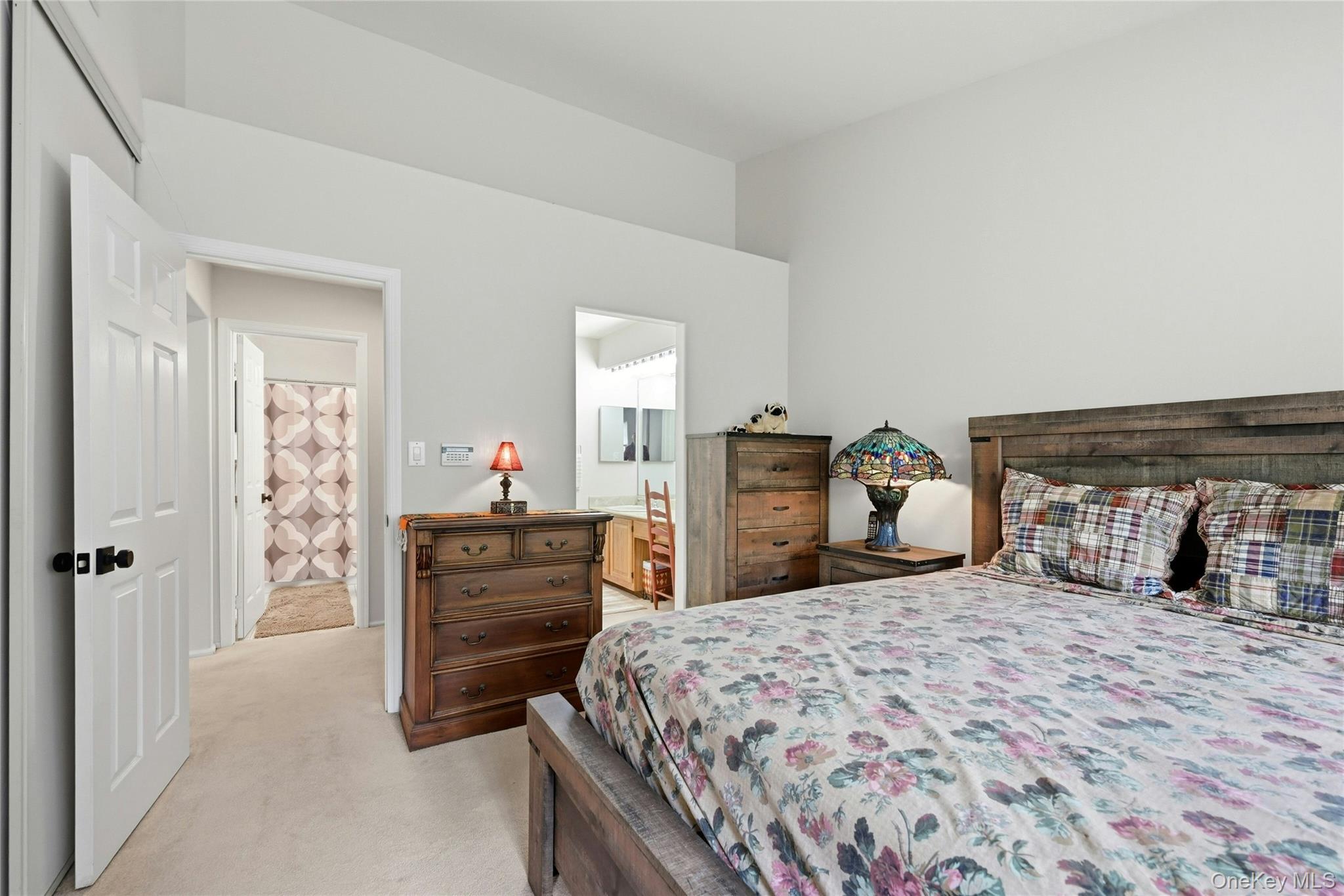 9 Baldwin Court, Unit 9 Ridge, NY 11961 - Photo 20 of 27 a bedroom with a bed and a dresser
