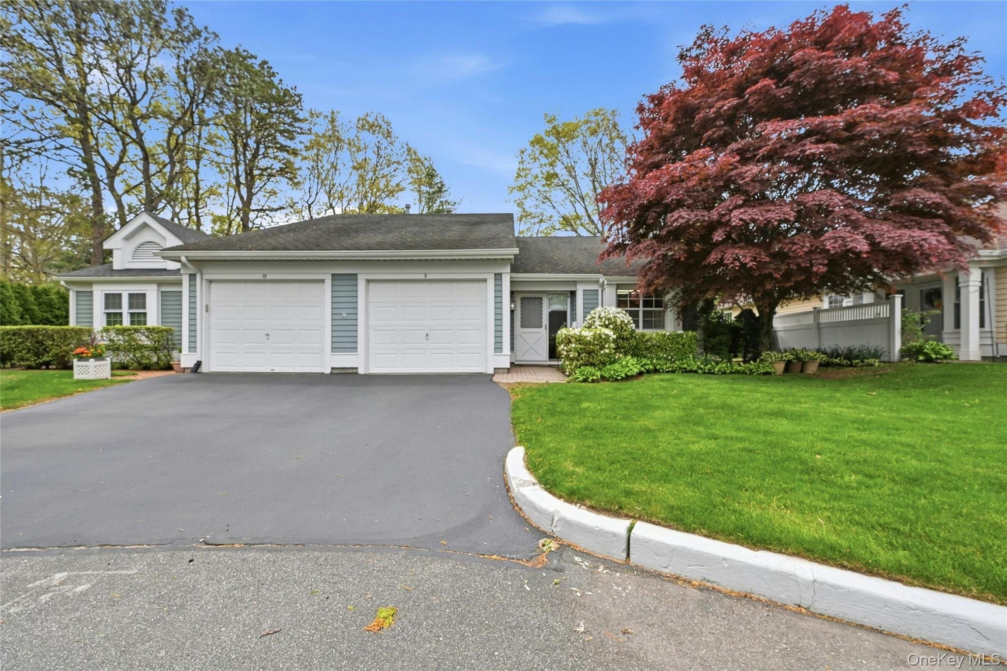 9 Baldwin Court, Unit 9 Ridge, NY 11961 - Photo 2 of 27 front view of house with a yard