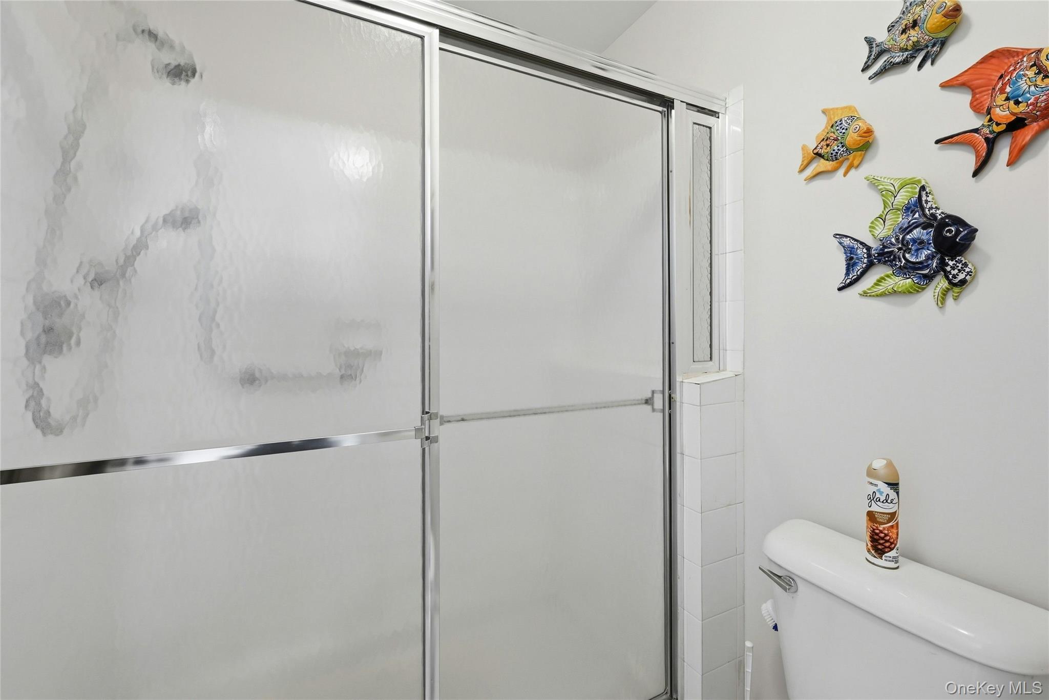 9 Baldwin Court, Unit 9 Ridge, NY 11961 - Photo 22 of 27 a bathroom with a shower toilet and sink