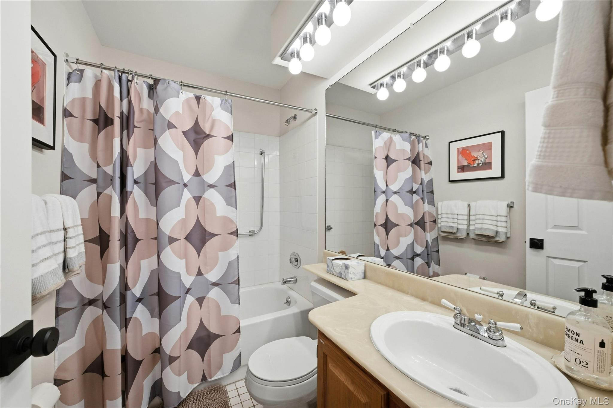 9 Baldwin Court, Unit 9 Ridge, NY 11961 - Photo 23 of 27 a bathroom with a sink vanity mirror and toilet