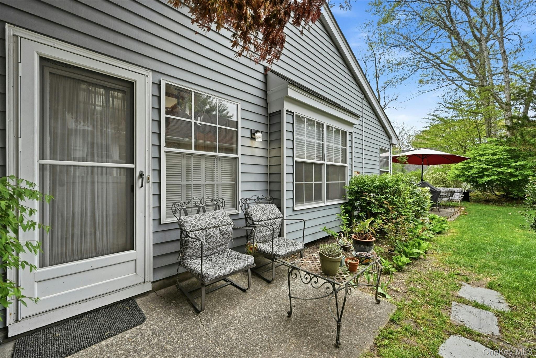 9 Baldwin Court, Unit 9 Ridge, NY 11961 - Photo 25 of 27 a view of a house with backyard and sitting area